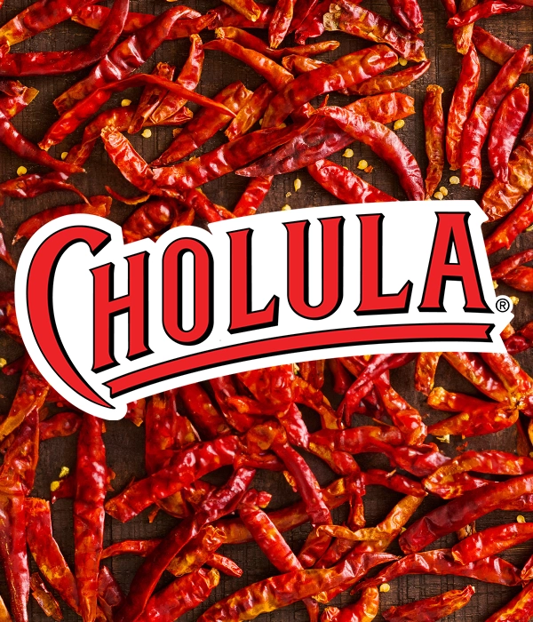 cholula logo on a background with red chilies